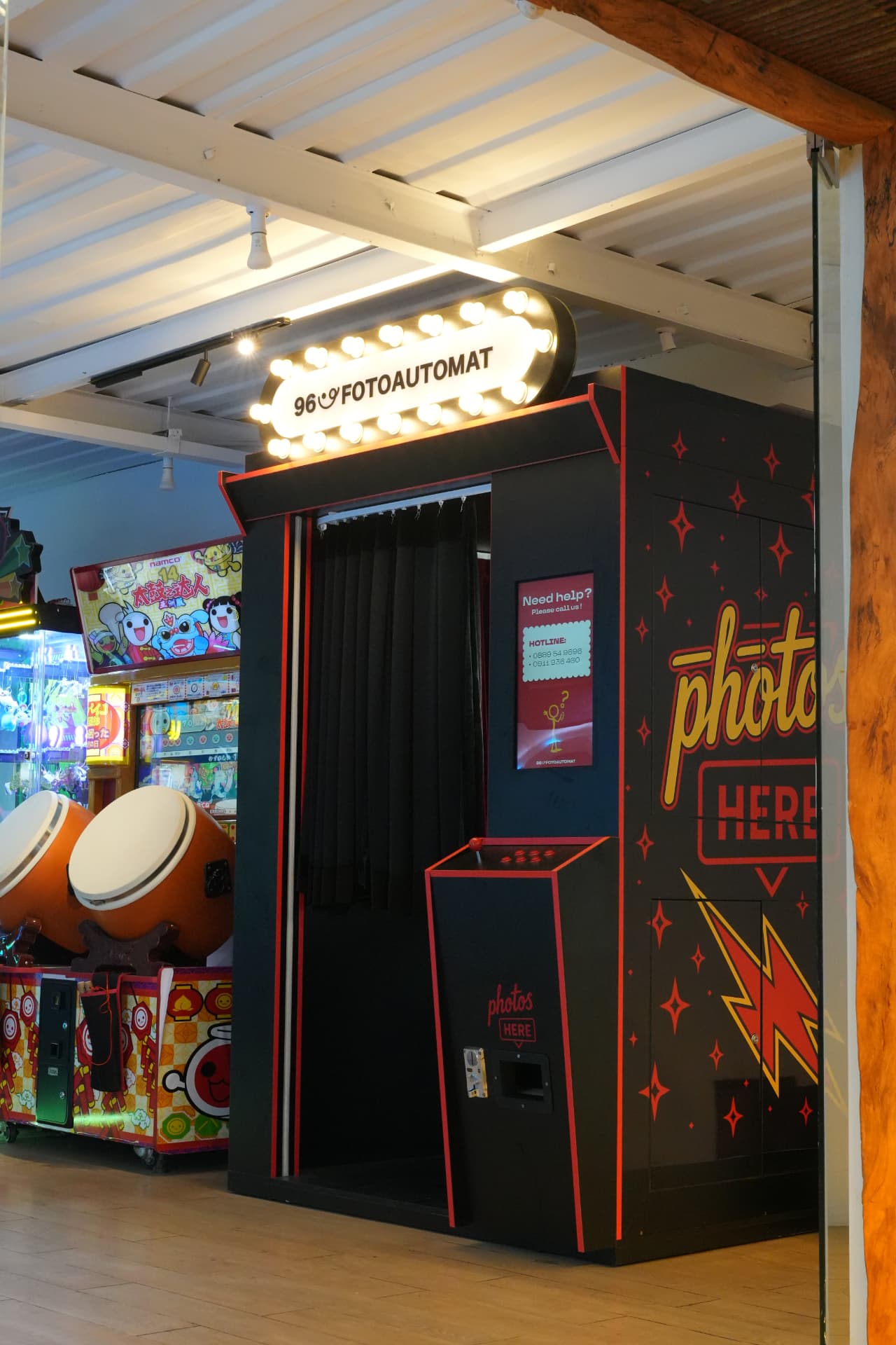 Bespoke arched red photobooth installed in a retail flagship